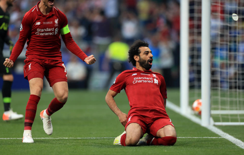 Liverpool's Mohamed Salah (right) celebrates scoring his side's first goal of the game during the UEFA Champions League Final at the Wanda Metropolitano, Madrid.