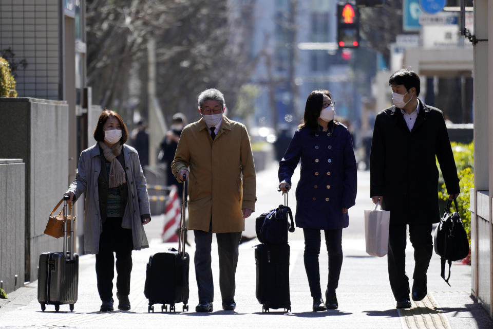 Lawyers of a Japanese air force serviceperson who filed a lawsuit against the government, walk to enter Tokyo District Court Monday, Feb. 27, 2023, in Tokyo. The plaintiff, who was only identified as a current member of the Air Self Defense Force, filed a lawsuit against the government on Monday, saying it failed to protect her from sexual harassment from a male colleague and then systematically covered up the problem for more than a decade.(AP Photo/Eugene Hoshiko)