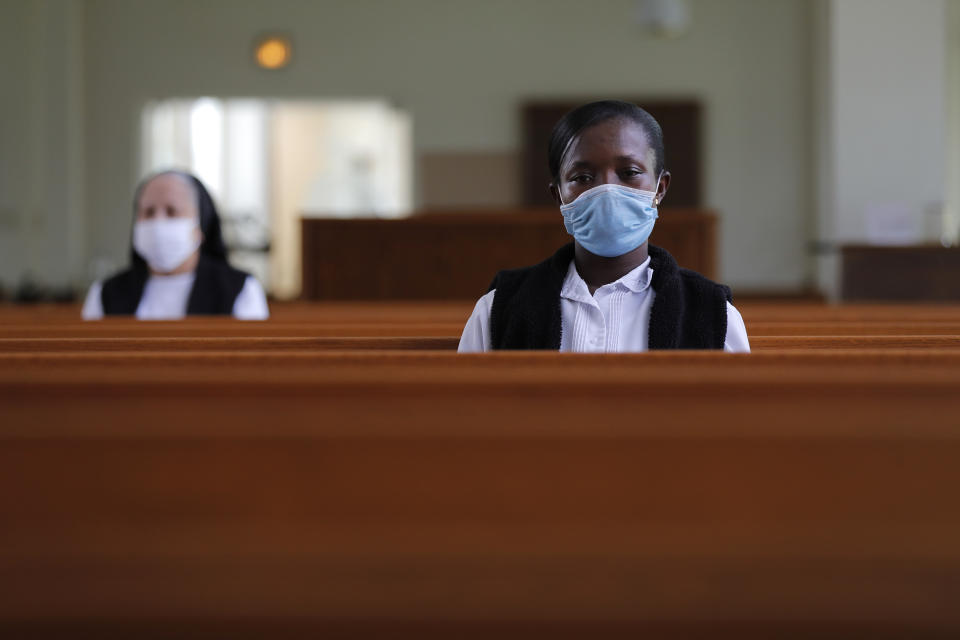 Faustina Bema, a candidate for Novice of the Sisters of the Holy Family, prays inside a chapel during a retreat at their Mother House in New Orleans, Thursday, July 23, 2020. In the archdioceses of New Orleans and Chicago, top leaders are encouraging their schools to place a new emphasis on teaching about racial justice, as well as the history of Black Catholics. (AP Photo/Gerald Herbert)