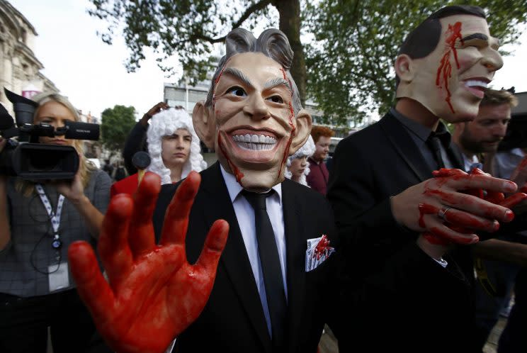 Demonstrators wearing masks portraying Blair and Bush protest before the release of the Chilcot report into the Iraq War at the Queen Elizabeth II Centre in London on Wednesday. (Photo: Peter Nicholls/Reuters)