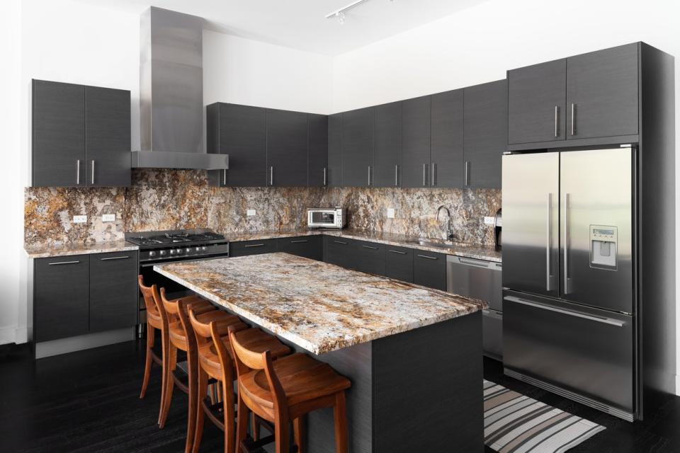 Kitchen with brown granite countertops and dark gray cabinets
