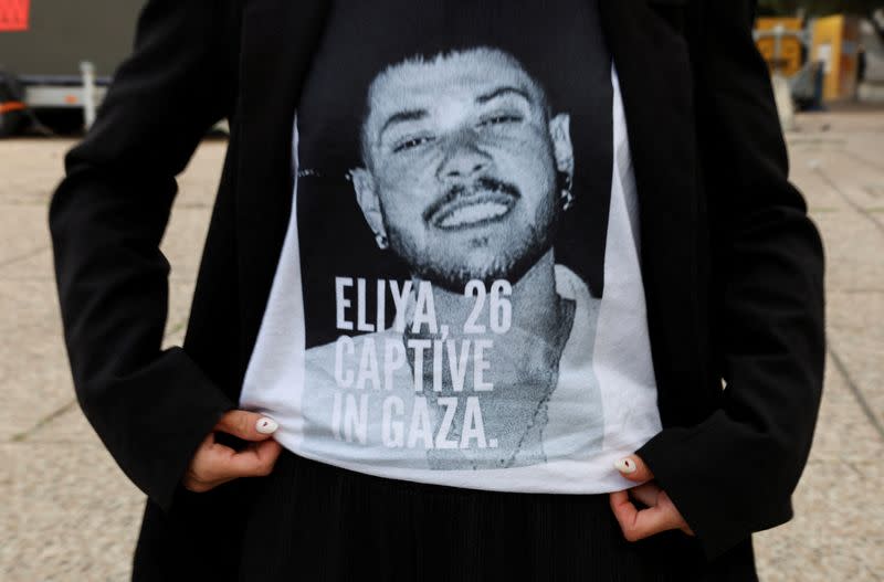 FILE PHOTO: Ziv Abud, the girlfriend of hostage Eliya Cohen, who was kidnapped during the October 7 attack on Israel by Palestinian Islamist group Hamas from Gaza, shows her t-shirt with a picture of Eliya during an interview with Reuters, in Tel Aviv