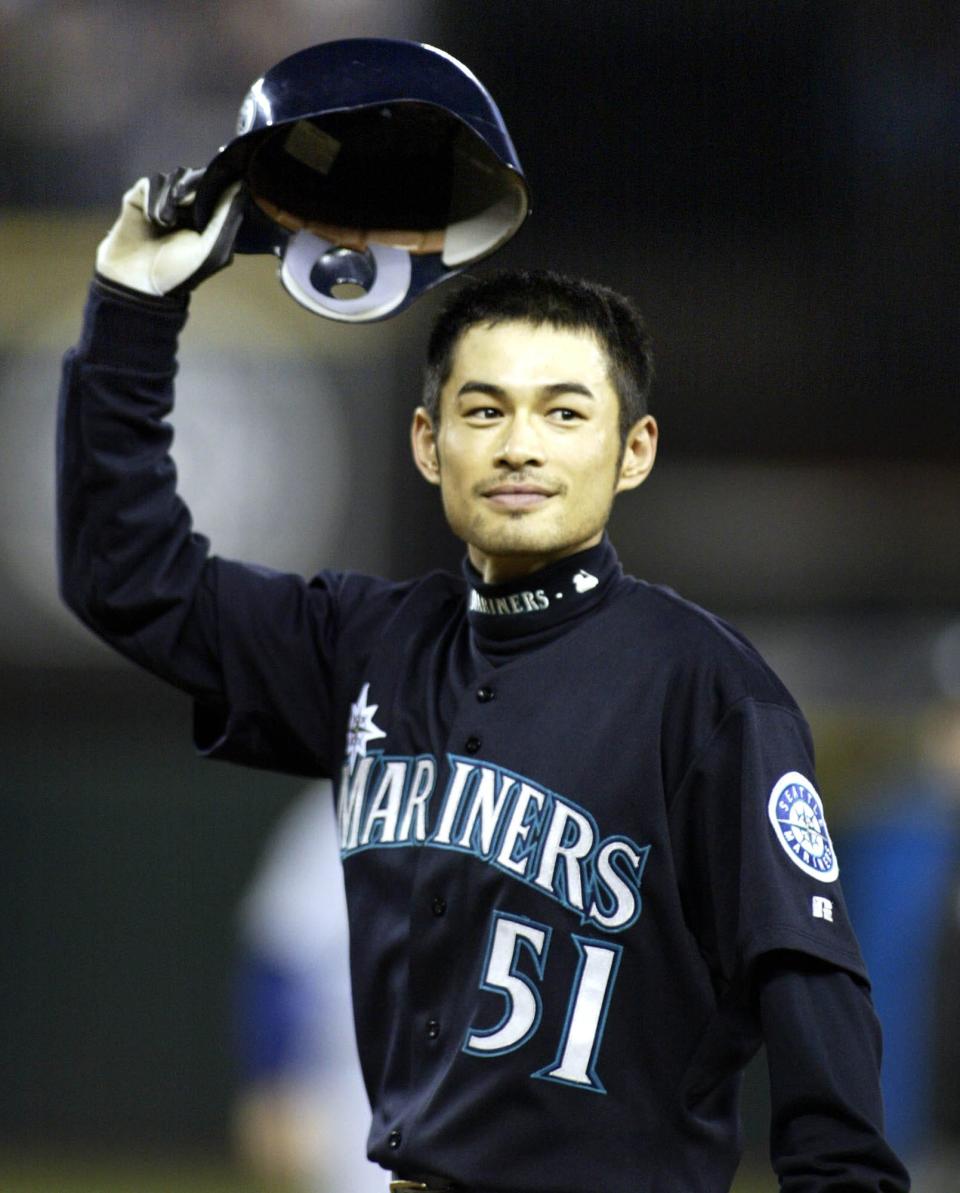 Ichiro Suzuki tips his hat to the fans after breaking the single-season hit record in 2004.