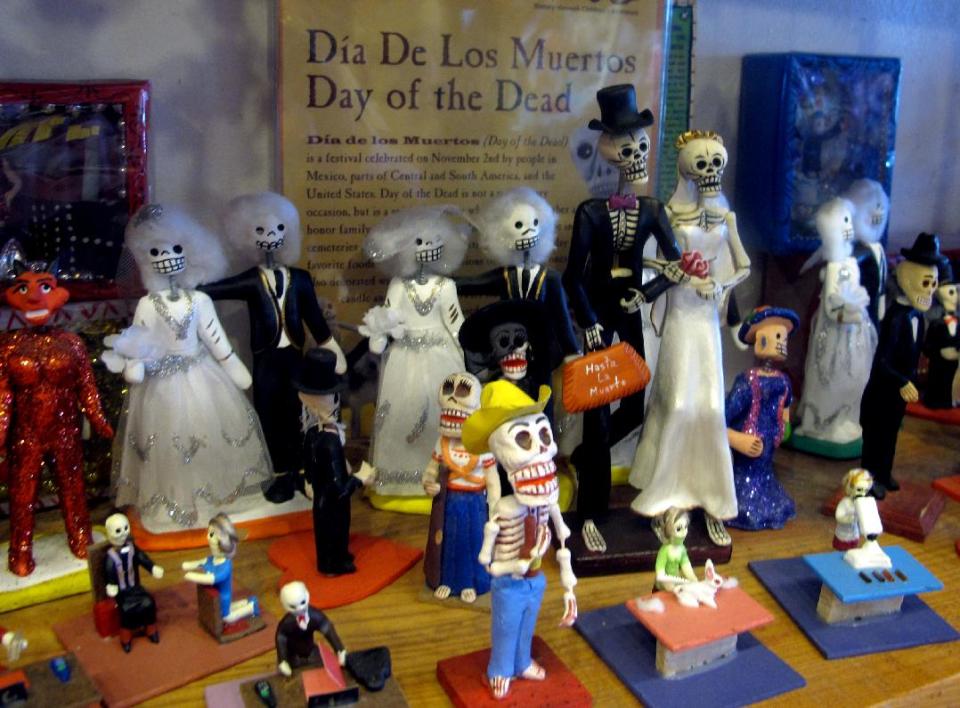 In this May 8, 2013 photo, artwork is shown at Masks y Mas, an Albuquerque shop that sells 'Day of the Dead' art year round. Disney announced Tuesday that it was a withdrawing a "Dia de los Muertos" trademark request it made to the U.S. Patent and Trademark Office amid uproar on social media from Latino activists, writer and artists. Disney had sought to secure naming right for an upcoming animated movie inspired by the holiday. Critics said the move to trademark a cultural holiday was insensitive. (AP Photo/Russell Contreras)