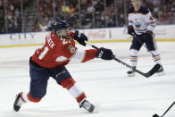 FILE - In this Feb. 15, 2020, file photo, Florida Panthers center Vincent Trocheck (21) shoots on the goal during the first period of an NHL hockey game against the Edmonton Oilers, in Sunrise, Fla. The Panthers traded Trocheck to the Carolina Hurricanes for Erik Haula, Lucas Wallmark and prospects Chase Priskie and Eetu Luostarinen, Monday, Feb. 24, 2020. (AP Photo/Lynne Sladky, File)