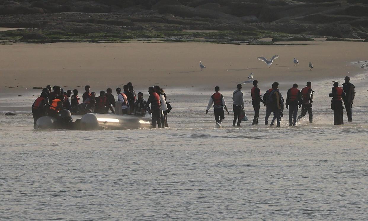 <span>People disembarking from a dinghy after an abortive attempt to cross the Channel from Le Portel in October.</span><span>Photograph: Pascal Rossignol/Reuters</span>