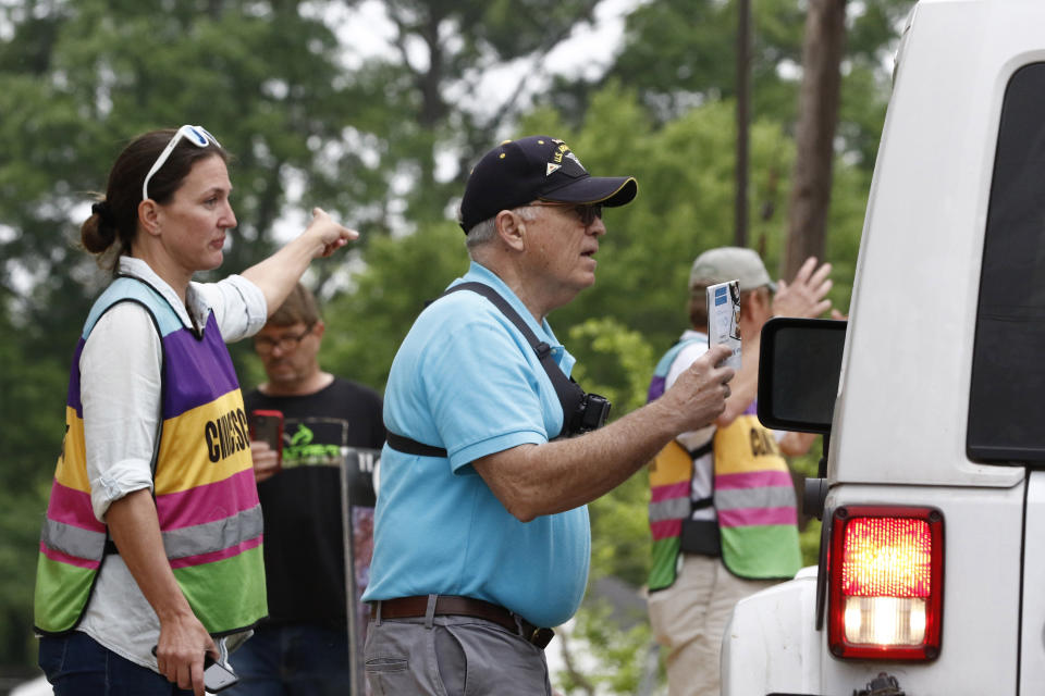 David Lane, right, an anti-abortion activist pleads with a driver and the patient to drive away and hold off having an abortion, to women as they are directed by clinic escort Scotta Brady to the parking lot of the Women's Health Organization clinic, Wednesday, March 25, 2020, in Jackson, Miss. The clinic is Mississippi's only state licensed abortion facility. Gov. Tate Reeves told reporters at a press conference on the coronavirus Tuesday that he considers abortion an elective and unnecessary procedure. (AP Photo/Rogelio V. Solis)