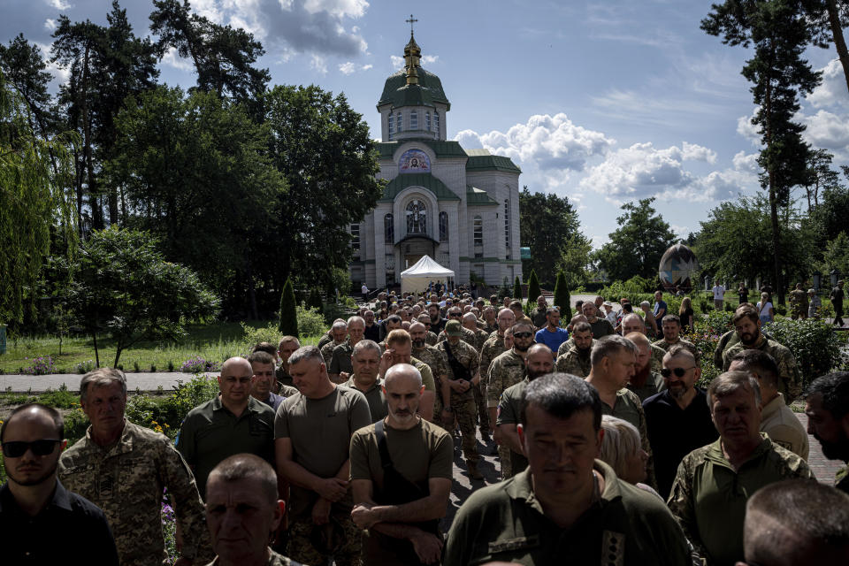 Ukrainian servicemen attend a farewell ceremony of their fallen comrade Nicholas Maimer, a U.S. citizen and Army veteran who was killed during fighting in Bakhmut against Russian forces, in Ukrajinka, Ukraine, Wednesday, July 19, 2023. (AP Photo/Evgeniy Maloletka)