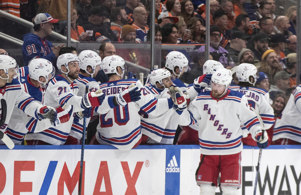 New York Rangers' Alexis Lafreniere (13) is congratulated for a goal against the Edmonton Oilers during the second period of an NHL hockey game Thursday, Oct. 26, 2023, in Edmonton, Alberta. (Jason Franson/The Canadian Press via AP)