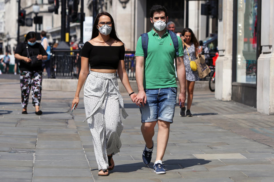 UK households People wearing protective face masks walk down Regent Street, London, on a hot summer's day.