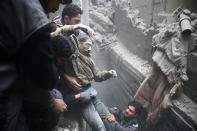 <p>Civil defence help a man from a shelter in the besieged town of Douma in eastern Ghouta in Damascus, Syria, Feb. 22, 2018. (Photo: Bassam Khabieh/Reuters) </p>