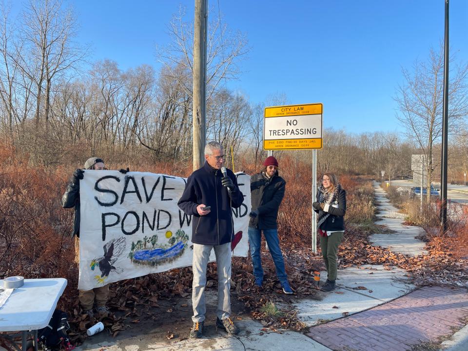 Akron resident and University of Akron biology professor Peter Niewiarowski speaks out in opposition Friday morning to plans by the city of Akron to develop a wooded site off White Pond Drive.