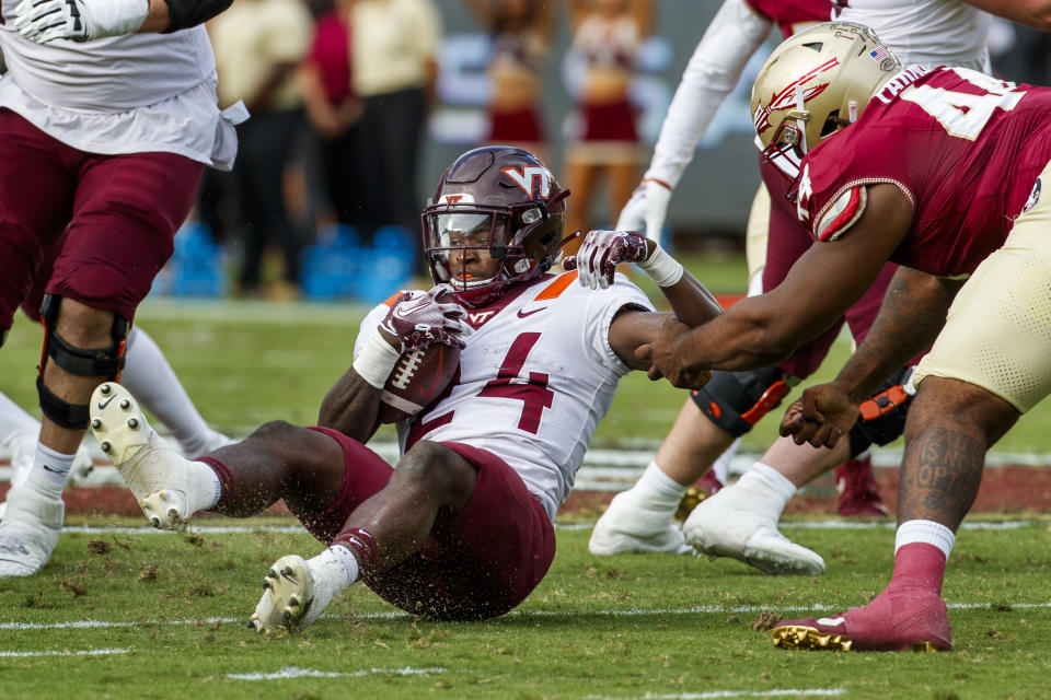 Virginia Tech running back Malachi Thomas (24) is arm tackled by Florida State defensive lineman Joshua Farmer (44) during the first half of an NCAA college football game, Saturday, Oct. 7, 2023, in Tallahassee, Fla. (AP Photo/Colin Hackley)