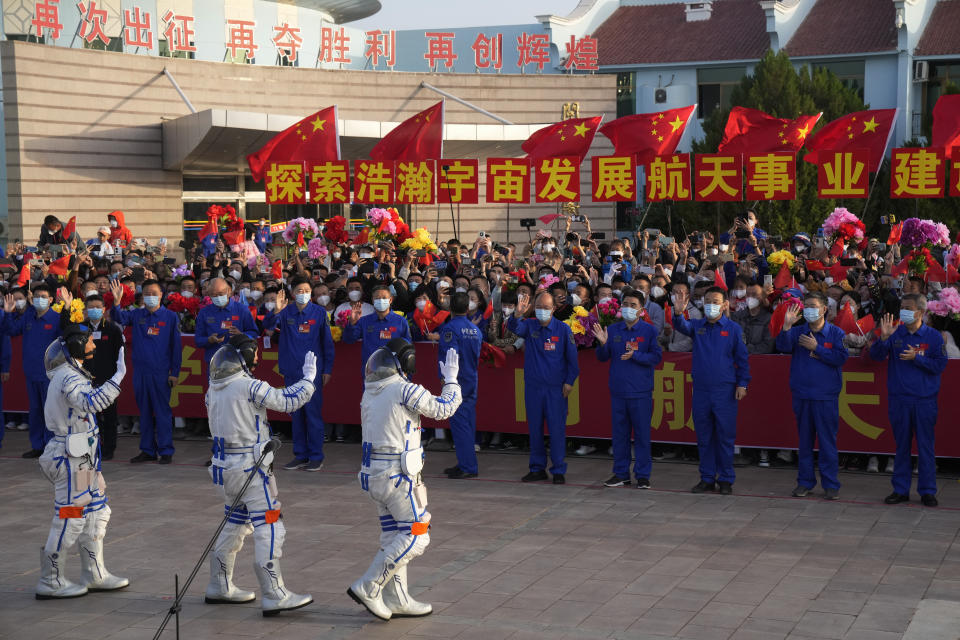 Chinese astronauts for the Shenzhou-16 mission, from left, Gui Haichao, Zhu Yangzhu and Jing Haipeng wave during a send-off ceremony for their manned space mission at the Jiuquan Satellite Launch Center in northwestern China, Tuesday, May 30, 2023. (AP Photo/Mark Schiefelbein)