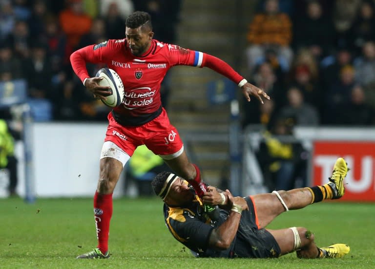 Toulon's Delon Armitage is tackled by Wasps' No. 8 Nathan Hughes during their European Rugby Champions Cup match, at The Ricoh Arena in Coventry, central England, on November 22, 2015