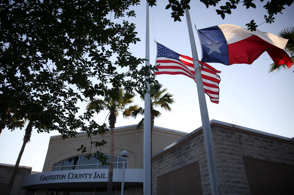 <p>Flags fly at half mast outside the Galveston County Jail in Galveston, Texas, U.S., where suspect Dimitrios Pagourtzis was charged in connection with a shooting that left several people dead at Santa Fe High School in Santa Fe, Texas, May 18, 2018. (Photo: Pu Ying Huang/Reuters) </p>