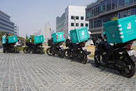 A delivery driver for the app Deliveroo prepares to make a delivery, in Dubai, United Arab Emirates, Thursday, Sept. 9, 2021. Advocates and workers say that casualties among food delivery riders are mounting in the city of Dubai, as the pandemic accelerates a boom in customer demand. The trend has transformed Dubai’s streets and drawn thousands of desperate riders, predominantly Pakistanis, into the high-risk, lightly regulated and sometimes-fatal work. (AP Photo/Jon Gambrell)