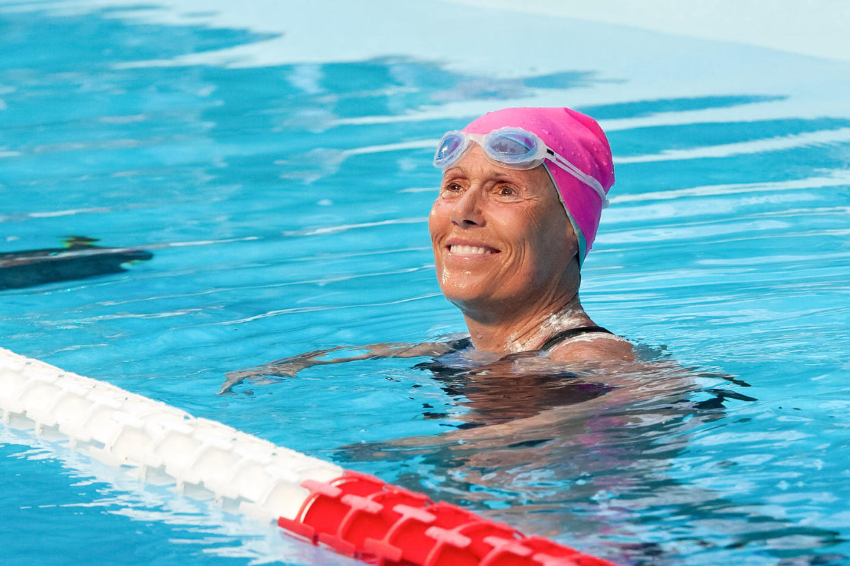 Diana Nyad smiles in a pool. She is wearing a pink swim cap. (D Dipasupil / FilmMagic via Getty Images file)