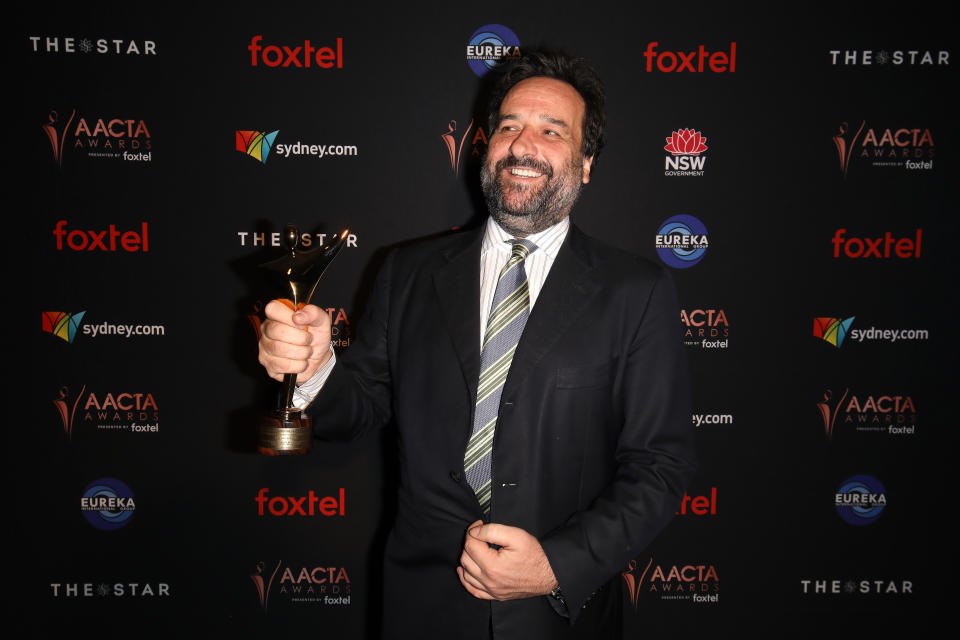 Seen here, Mick Molloy poses with the AACTA Award for Best Sports Entertainment Program in the media room during the 2019 AACTA Awards night.