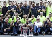 Red Bull Formula One driver Sebastian Vettel of Germany (C, bottom) celebrates his win with the Red Bull team after the Austin F1 Grand Prix at the Circuit of the Americas in Austin November 17, 2013.