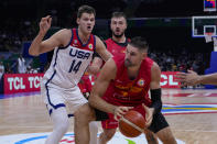 Montenegro center Nikola Vucevic (4) looks to shoot in front of U.S. center Walker Kessler (14) during the first half of a Basketball World Cup second round match in Manila, Philippines Friday, Aug. 1, 2023. (AP Photo/Michael Conroy)