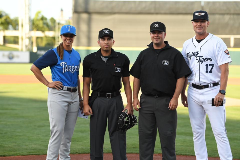 Rachel Balkovec, from left, stands next to the opening day umpires and Flying Tigers manager Andrew Graham. Balkovec is the first woman manager in the minors and pros.