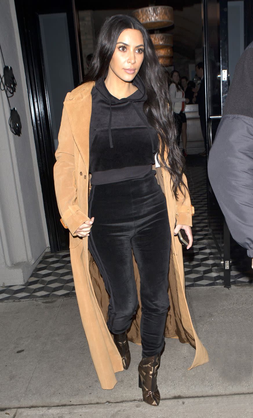 <p>In a floor-length suede overcoat, black velour tracksuit, and black-tinted transparent boots while out in West Hollywood. </p>