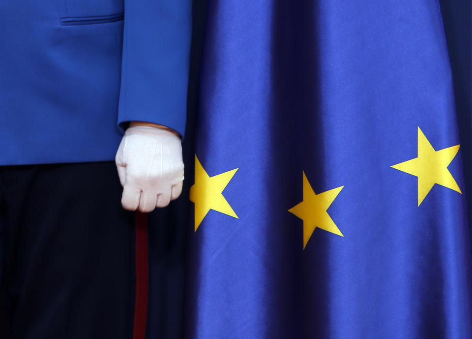 A member of the Serbian honour guard stands by EU flag during a press conference of Czech Prime Minister Andrej Babis and his Serbian counterpart Ana Brnabic at the Serbia Palace in Belgrade, Serbia, Wednesday, Feb. 10, 2021. Babis is on a one-day official visit to Serbia. (AP Photo/Darko Vojinovic)