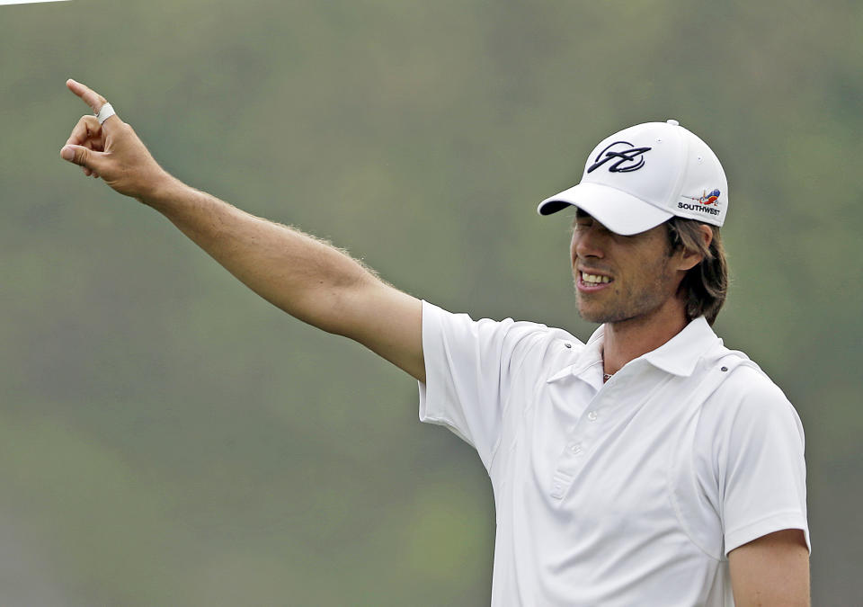 Aaron Baddeley, of Australia, gestures to his right after after teeing off on the ninth hole during the third round of the Northern Trust Open golf tournament at Riviera Country Club in the Pacific Palisades area of Los Angeles Saturday, Feb. 15, 2014. (AP Photo/Reed Saxon)