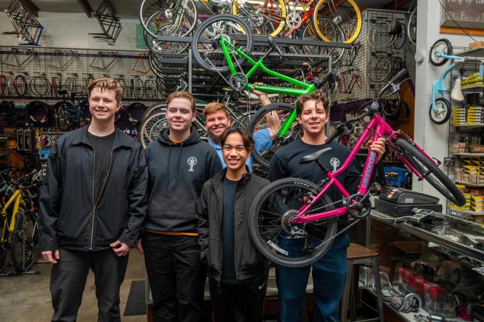 Owen Wilber, 17, left, Rowan Diepenbrock, 19, Riley Domine, 17, and Winston Holtkamp, 17, right, of Boys 4 Bikes stand with Jeff Dzurinko of the Sutterville Bicycle Company, rear, to pick up 40 bikes Friday, Dec. 8. They started Boys 4 Bikes when they were in elementary school, raising money to buy bikes to be distributed to underprivileged youth. They’re asking readers of Book of Dreams for $5,000 to help continue their mission. José Luis Villegas/Special to The Bee