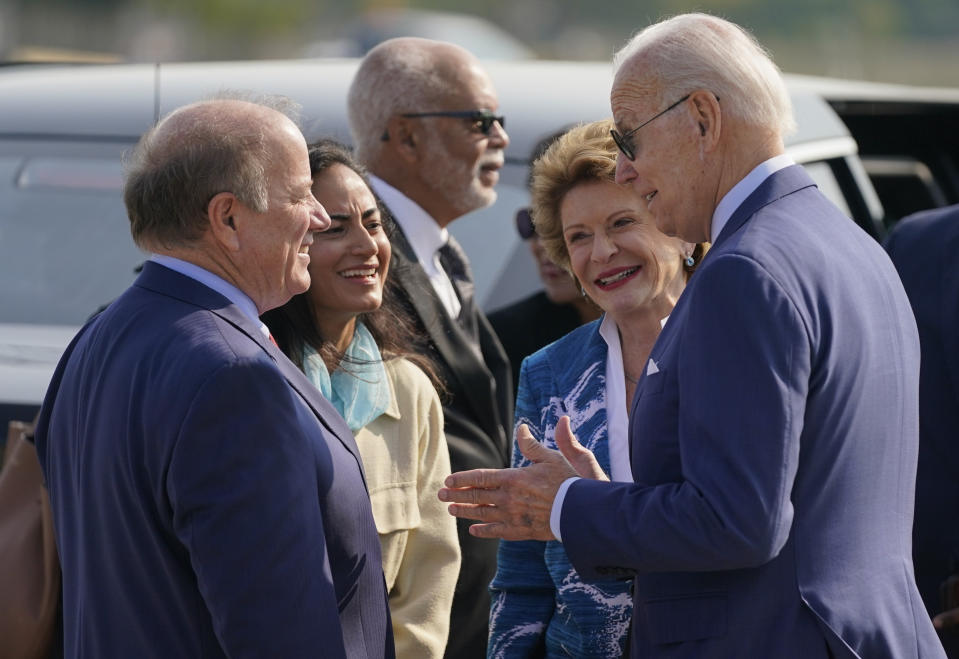 President Joe Biden speaks with Sen. Debbie Stabenow, D-Mich., second from right, Detroit Mayor Mike Duggan and wife Sonia Hassan as he arrives at Detroit Metropolitan Airport, Wednesday, Sept. 14, 2022, in Detroit. (AP Photo/Evan Vucci)