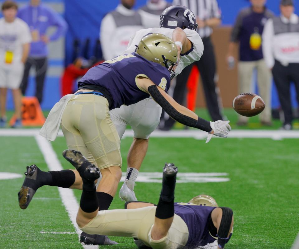 Hudsonville Unity Christian quarterback #8 Camron Chandler fumbles the football with Chelsea recovering during first half action the Michigan High School Athletic Association division four football game between Chelsea and Hudsonville Unity Christian at Ford Field in Detroit on Friday Nov, 26, 2021.