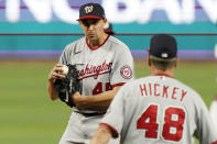 Washington Nationals pitching coach Jim Hickey (48) approaches the mound to talk with starting pitcher Aaron Sanchez during the second inning of a baseball game against the Miami Marlins, Monday, May 16, 2022, in Miami. (AP Photo/Lynne Sladky)