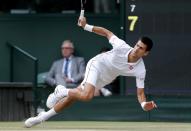 Novak Djokovic of Serbia slips during his men's singles final tennis match against Roger Federer of Switzerland at the Wimbledon Tennis Championships, in London July 6, 2014. REUTERS/Stefan Wermuth
