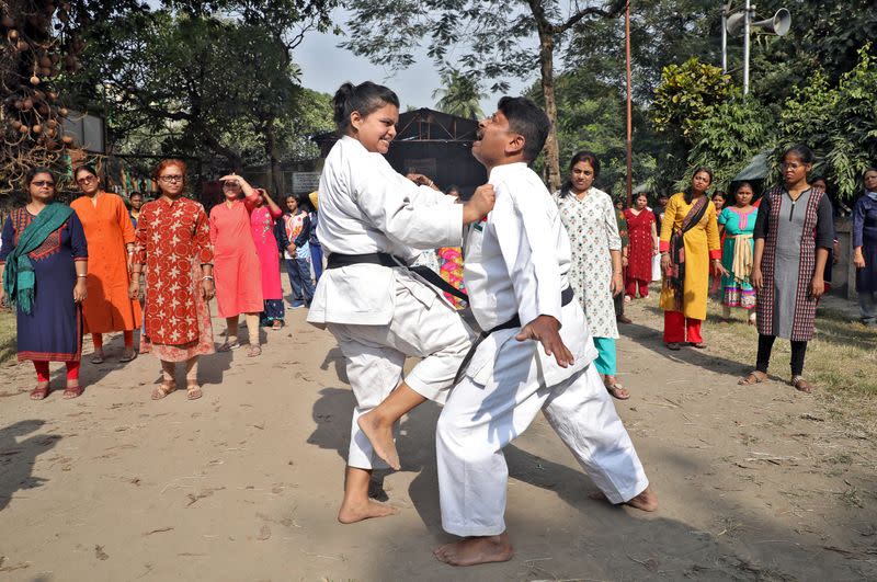 Instructors demonstrate self-defense techniques to women at a training camp in Kolkata