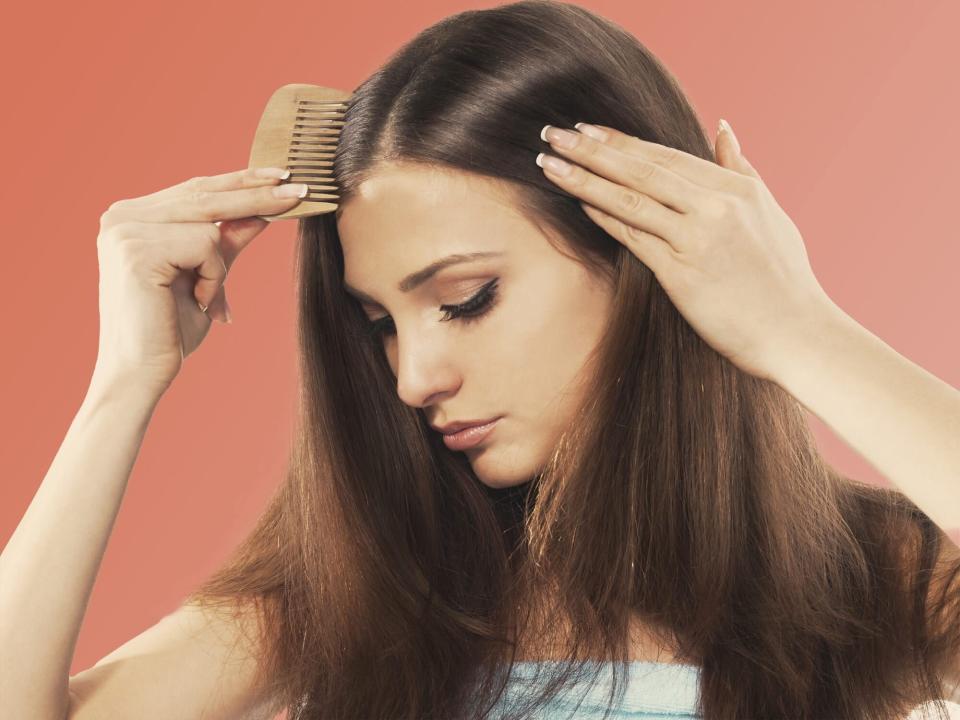 a woman combing her long hair