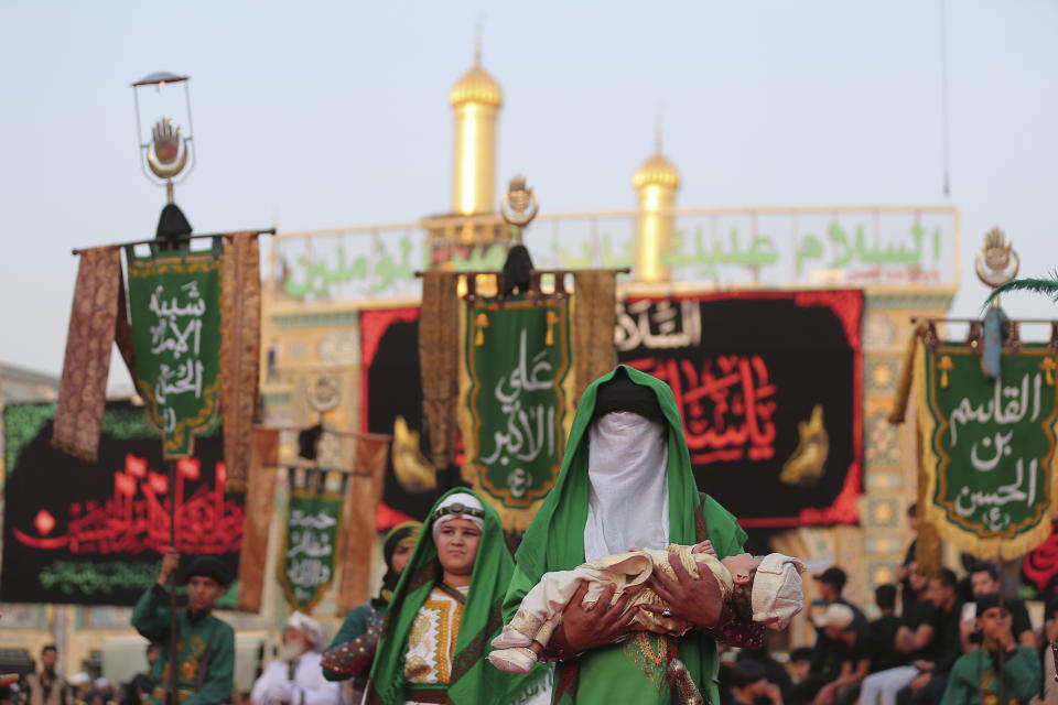 Iraqi Shiites take part in Ashura that marks the martyrdom of Husayn ibn Ali, a grandson of the Islamic prophet Muhammad, and members of his immediate family in the Battle of Karbala, in Karbala, Iraq, Monday, Aug. 8, 2022. (AP Photo/Anmar Khalil)