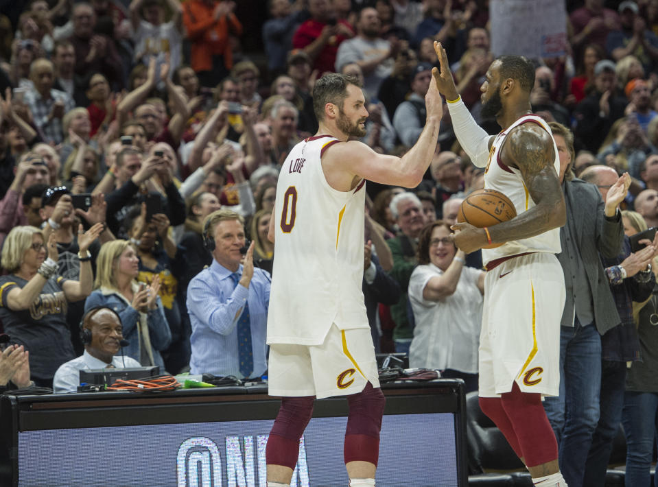 FILE - Cleveland Cavaliers' LeBron James, right, is congratulated by Kevin Love, after Jame's 867th consecutive game scoring in double figures during the first half of an NBA basketball game against the New Orleans Pelicans in Cleveland, Friday, March 30, 2018. James surpassed the old mark of 866 held by Michael Jordan. Cavaliers forward Love, in an essay for The Associated Press, reflected on his years as James' teammate. James is about to pass Kareem Abdul-Jabbar for the NBA career scoring record. (AP Photo/Phil Long, File)