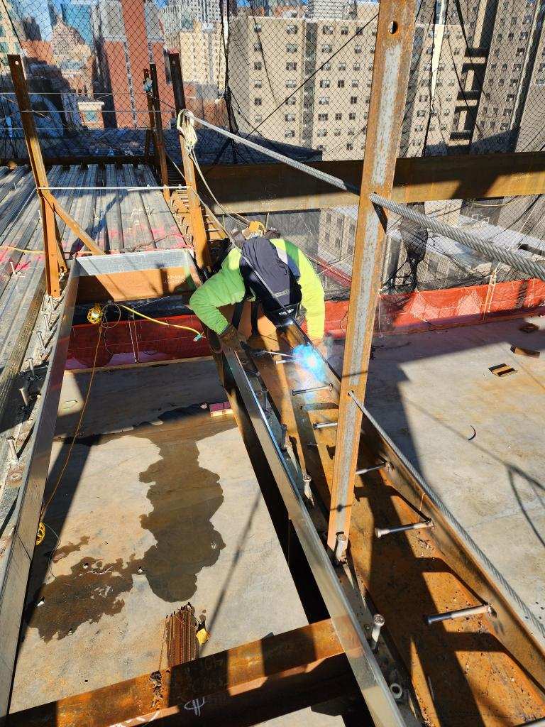 Stoughton ironworker Jessica Devance welds at the Josiah Quincy Upper School she and coworkers are building in Boston's Chinatown.
