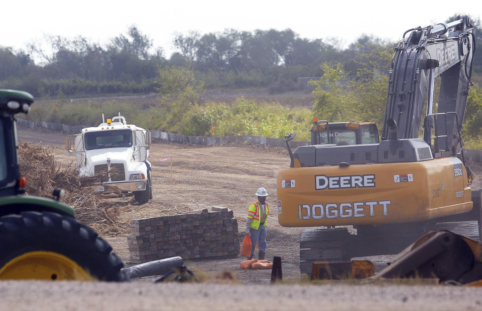 Construction workers clear land in preparation for the new border wall construction Friday, Oct. 11, 2019, south of Donna, Texas.(Joel Martinez/The Monitor via AP)