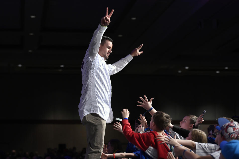 Chicago Cubs' Kyle Schwarber waves to the crowd after being announced during the baseball team's convention, Friday, Jan. 17, 2020, in Chicago. (AP Photo/Paul Beaty)