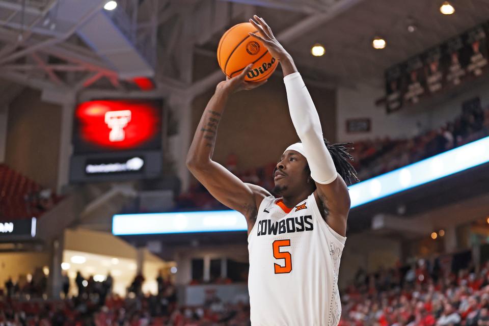 OSU's Caleb Asberry (5) shoots a 3-pointer during the first half at Texas Tech on Saturday.