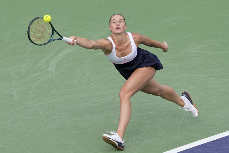 Marta Kostyuk, of Ukraine, returns to Iga Swiatek, of Poland, during a semifinal match at the BNP Paribas Open tennis tournament, Friday, March 15, 2024, in Indian Wells, Calif. (AP Photo/Mark J. Terrill)