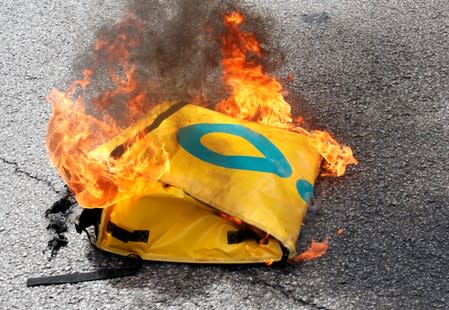 FILE PHOTO: A burning Govo delivery bag during a protest after the death of a delivery rider in Barcelona