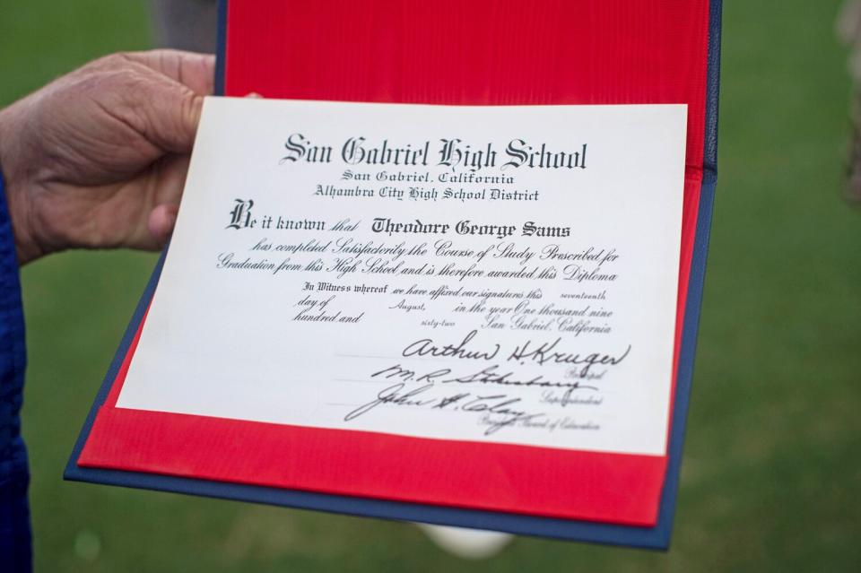 Ted Sams, 78, receives his original high school diploma during San Gabriel High School's graduation at the Rose Bowl on Friday, May 27, 2022, in Pasadena, Calif.