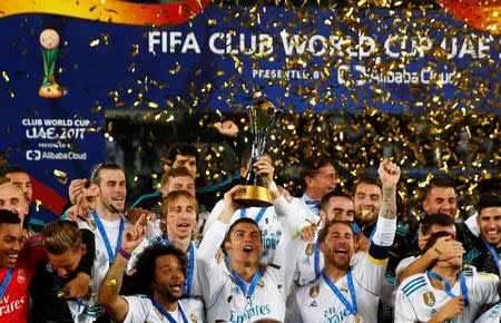 Soccer Football - FIFA Club World Cup Final - Real Madrid vs Gremio FBPA - Zayed Sports City Stadium, Abu Dhabi, United Arab Emirates - December 16, 2017 Real Madrid’s Cristiano Ronaldo and team mates celebrate with the trophy after winning the FIFA Club World Cup REUTERS/Amr Abdallah Dalsh