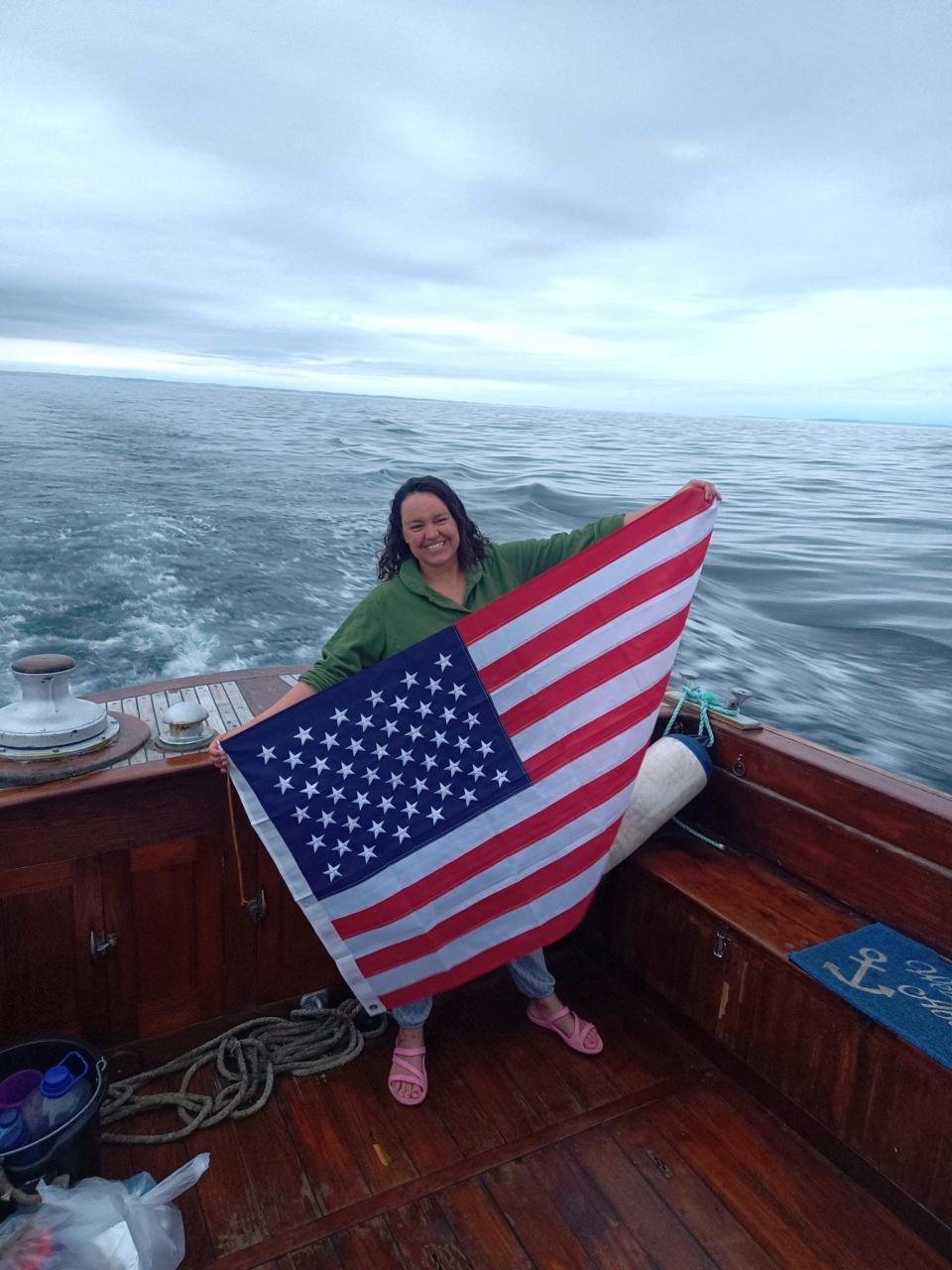 Morton native Bethany Mitchell celebrates with an American flag after becoming the 23rd American since 1947 to successfully swim across the North Channel between Ireland and Scotland on July 27, 2023.