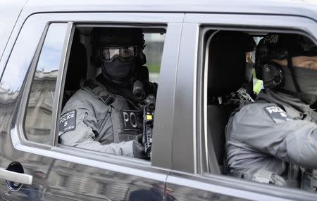 Armed police ride a vehicle in Israel's Prime Minister Benjamin Netanyahu's caravan as he arrives to visit Britain's Prime Minister Theresa May at Downing Street in London, Britain, February 6, 2017. REUTERS/Dylan Martinez