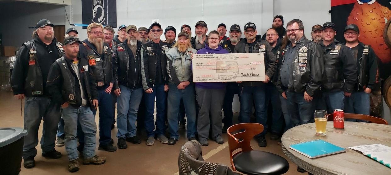 The Clark County Riders Motorcycle Club purchased a dog kennel for the new building at the Aberdeen Area Humane Society. Accepting the check on behalf of the Aberdeen Area Human Society is Elaine Schaible, center.