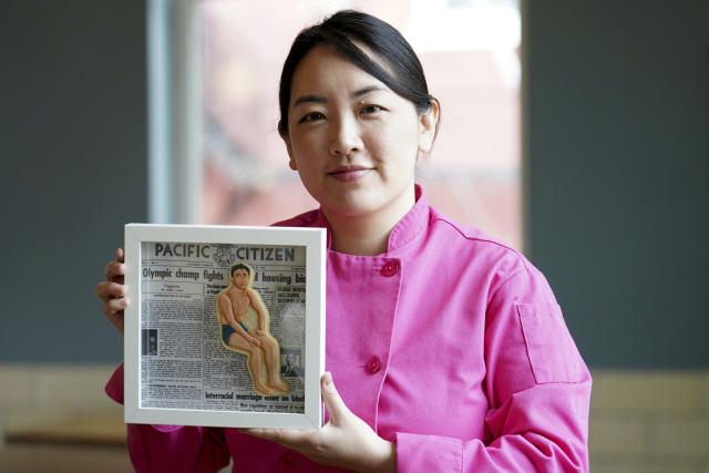 Jasmine Cho holds a framed cookie portrait of US Olympic gold medal winner Sammy Lee in Pittsburgh, Pa., Wednesday, May 3, 2023. Cho, a Korean American self-described “cookie activist,” has gained fans over the last several years for her finely detailed cookie mugs of famous and forgotten figures. (AP Photo/Matt Freed)